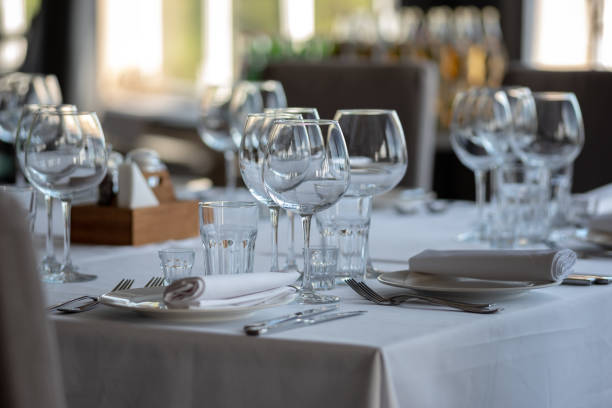 istock Empty glasses in restaurant background. Table set for an event party or wedding reception. 1254189312