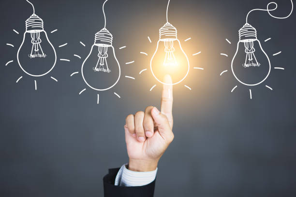 Businessman hand touching light bulbs, new ideas with innovative technology and creativity.