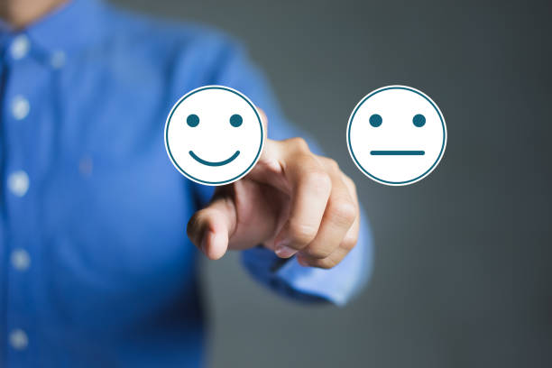 Businessman hand pointing the smiley face icon, Rating for a Satisfaction Survey, Customer Experience Concept stock photo