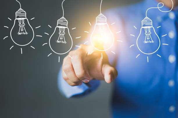 istock Businessman hand touching light bulbs, new ideas with innovative technology and creativity. 1254196465