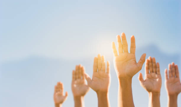 istock People raising hands for participation, many people's hands up. teamwork and competition concept 1254197147