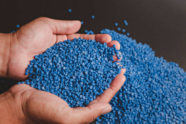 istock Blue plastic grain, plastic polymer granules,hand hold Polymer pellets, Raw materials for making water pipes, Plastics from petrochemicals and compound extrusion, resin from plant polyethylene. 1254197422