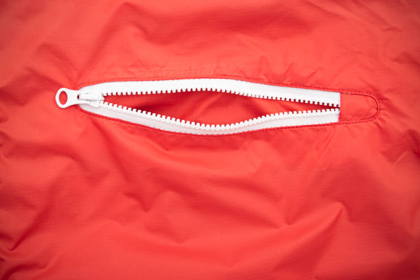 White open zip or zipper on a red jacket