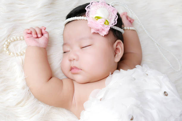 istock Cute newborn baby sleep on white fabric background. 1254200896