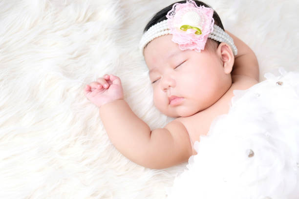 istock Closeup of infant baby sleeping on white background. 1254201823
