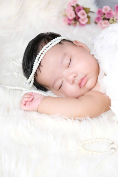 istock Cute newborn baby sleep on white fabric background. 1254201898