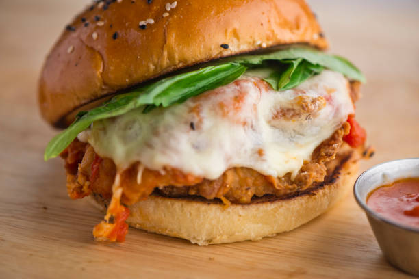 istock Chicken sandwich served with grilled or fried chicken breast on toasted grain bread w/ melted Swiss cheese, sautéed onions, lettuce, tomato, mayonnaise and seasoned salt and pepper. Classic American restaurant or diner lunch sandwich favorite. 1254202100