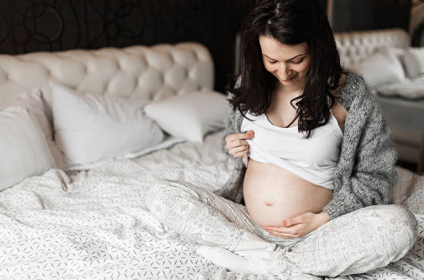 istock Pregnant woman resting in bed 1254202806