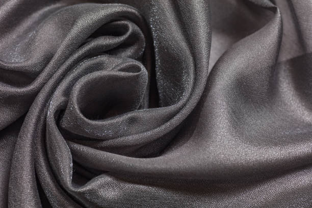 istock Shiny grey cloth background dark curly background 1254203103
