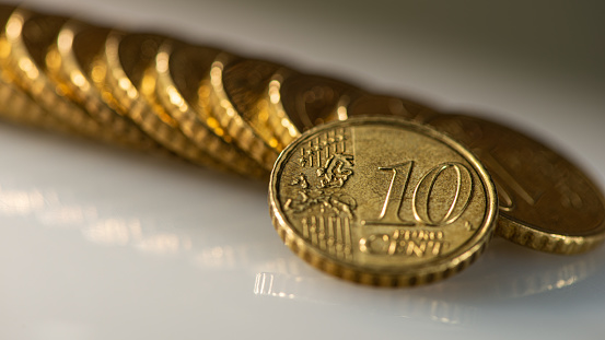 Coin ten euro cents and a stack of coins lies on the surface of the table. Web banner. Business concept.