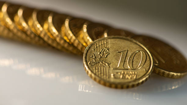 Coin ten euro cents and a stack of coins lies on the surface of the table. Coin ten euro cents and a stack of coins lies on the surface of the table. Web banner. Business concept. cent sign photos stock pictures, royalty-free photos & images