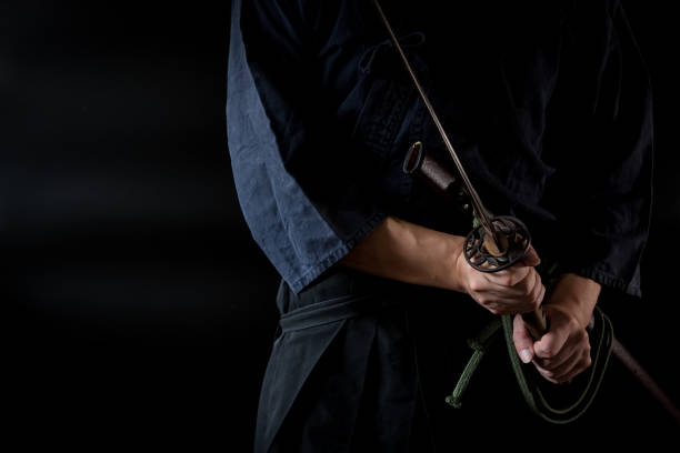 istock The man holding japanese sword 1254205617