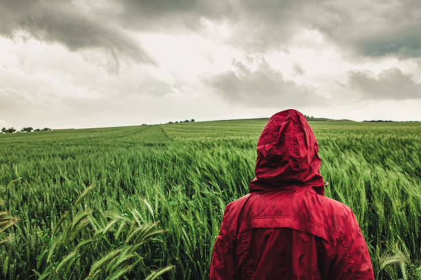istock Woman enjoying rainy grey springtime day outdoors. soft daylight 1254210276