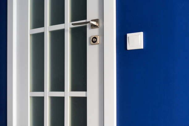 istock White interior door with handle. Blue wall in modern apartment 1254211381