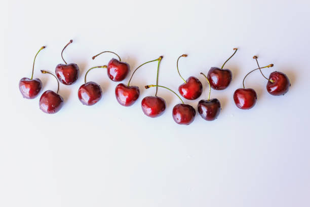 istock Frame of ripe cherry berries on a white background. Copy space. Fresh berries at summer. 1254211901