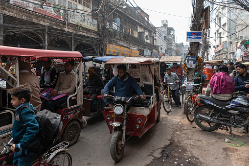 Tuk-tuk and rickshaw traffic jam in a crowded street of Old Delhi (India).