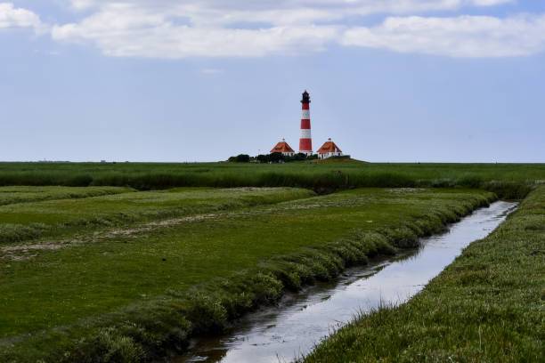 istock The famous lighthouse in Westerhever with a great sky and clouds 1254212830