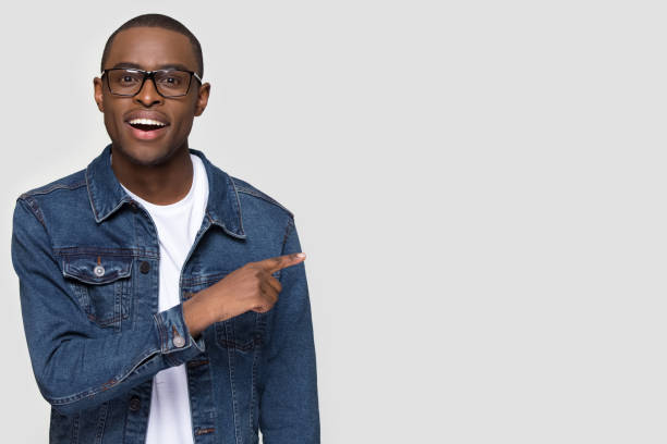 istock Happy African American man pointing finger at copy space 1254214842