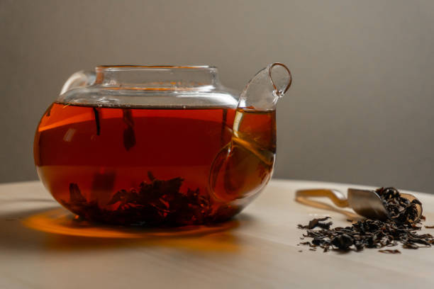 istock Teapot full of black brewed tea, side view 1254215178