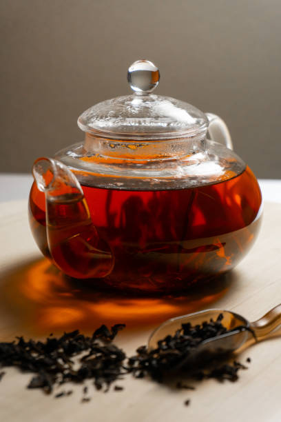 istock Black tea brewed in teapot on wooden table 1254215229
