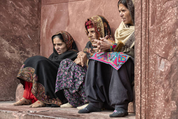 Muslim women attending prayers Three Muslim women, sitting in a niche, against a wall.  They are waiting for the next praying time in Jama Masjid, Old Delhi, India. old delhi stock pictures, royalty-free photos & images