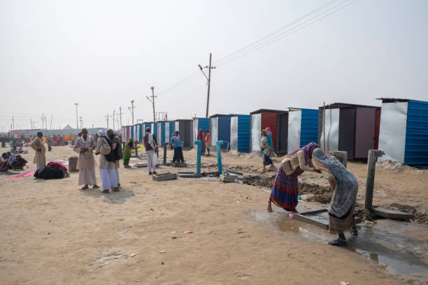 Temporary toilets in Kumbh Mela Tent City Temporary toilets and water taps in Kumbh Mela tent city, part of the 120.000 installed for the festival. Photo taken during Kumbh Mela 2019 in Prayagraj (Allahabad), India. 
Kumbh Mela or Kumbha Mela is a major pilgrimage and festival in Hinduism, and probably the greatest religious festival in the World. It is celebrated in a cycle of approximately 12 years at four river-bank pilgrimage sites: the Allahabad (Ganges-Yamuna Sarasvati rivers confluence), Haridwar (Ganges), Nashik (Godavari), and Ujjain (Shipra). The festival is marked by a ritual dip in the waters, but it is also a celebration of community commerce with numerous fairs, education, religious discourses by saints, mass feedings of monks or the poor, and entertainment spectacles. Pilgrims believe that bathing in these rivers is a means to cleanse them of their sins and favour a better next incarnation. prayagraj photos stock pictures, royalty-free photos & images
