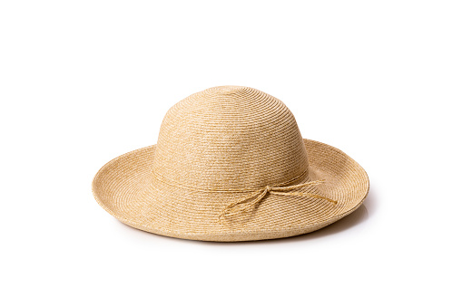 Studio photo of a flying straw hat isolated on white. The concept of fashion and vacation at the resort or in the garden