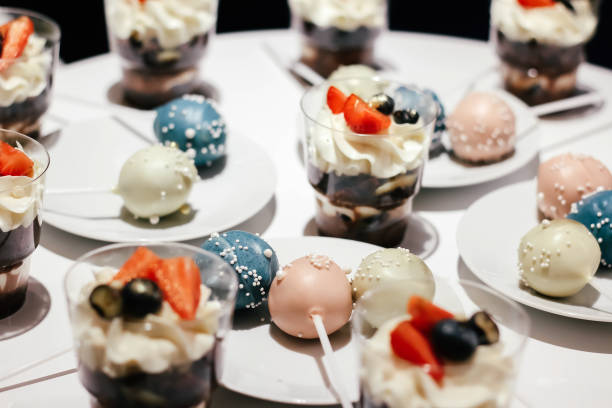 istock Desserts with whipped cream and strawberries on a white table. Glamorous style 1254225644