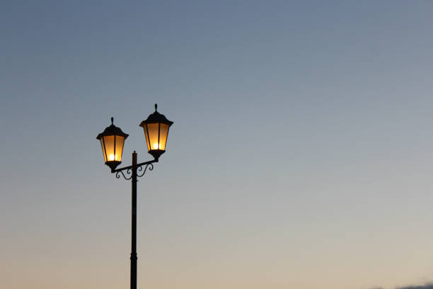 istock Two lamps against the sky without clouds 1254225758