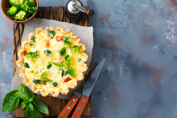 homemade quiche tart with red fish salmon, broccoli, basil, seasonings and cheese on a gray stone background. selective focus.top view. - baking flour ingredient animal egg imagens e fotografias de stock