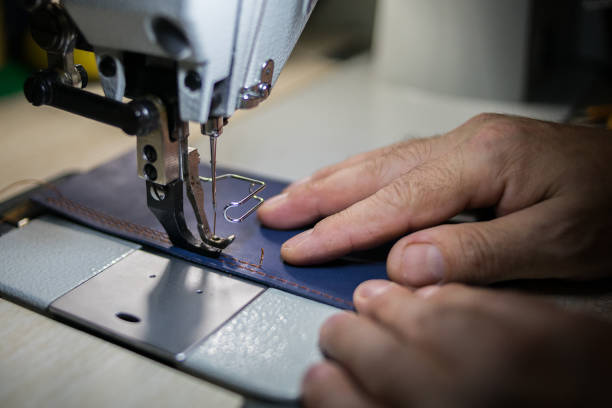 istock A man sews from leather on a sewing machine. Hands and sewing. 1254226844