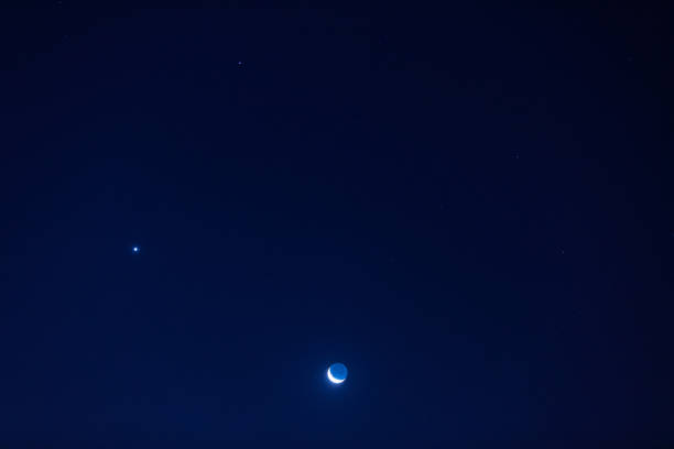 istock Young Moon and Venus on a dark night sky. 1254227862