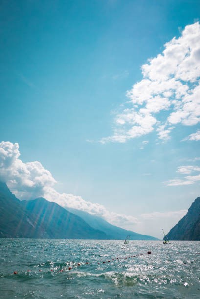 Garda Lake afternoon view, sailboat and windsurf in water – Torbole, Lombardy, Italy