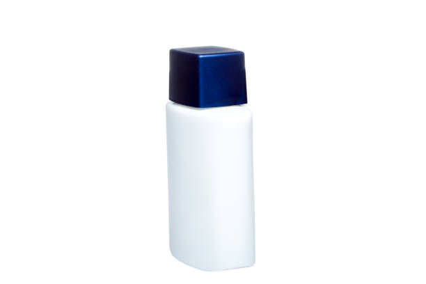 istock glass bottle no label white colore with blue plastic cap isolated on white background side view. 1254229097