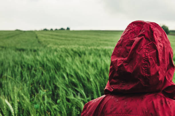 istock Woman enjoying rainy grey springtime day outdoors. Soft daylight 1254231274