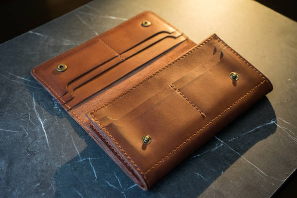 istock U-turn brown handmade leather wallet. leather purse on a dark background 1254232995