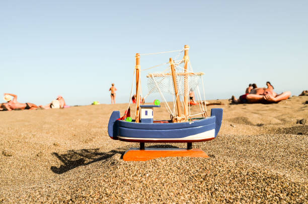Toy Boat on the Sand Beach Photo Picture of a Toy Boat on the Sand Beach 8564 stock pictures, royalty-free photos & images
