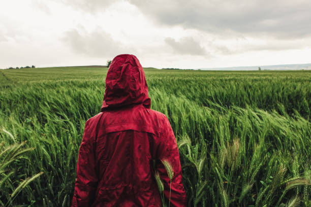 Woman enjoying rainy grey springtime day outdoors. Soft daylight