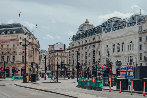 London, UK - June 13, 2020: View of nearly empty Piccadilly Circus, one of the most popular and typically very busy tourist areas in London, UK, on a sunny summer day.