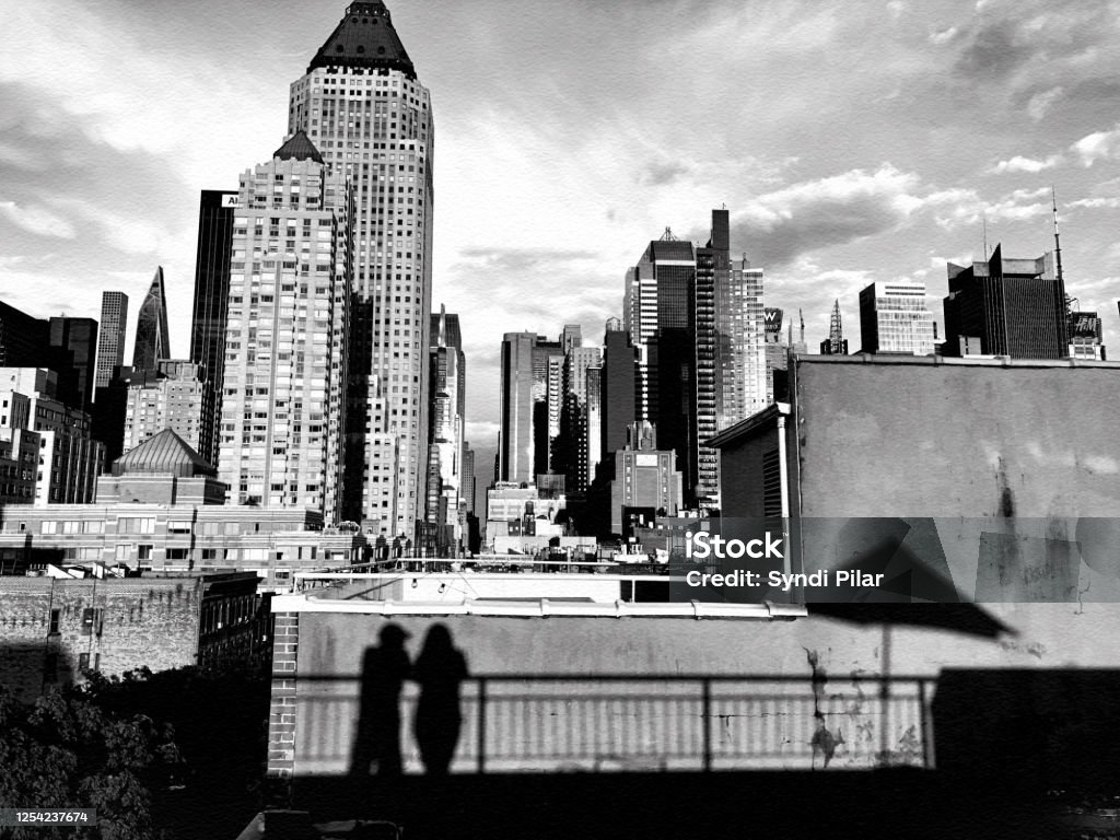 NYC, 06/28/20, Rooftop View from Hell's Kitchen NYC, 06/28/20. Shadows of a couple and Umbrella from a rooftop in Hell's Kitchen. New York City Stock Photo