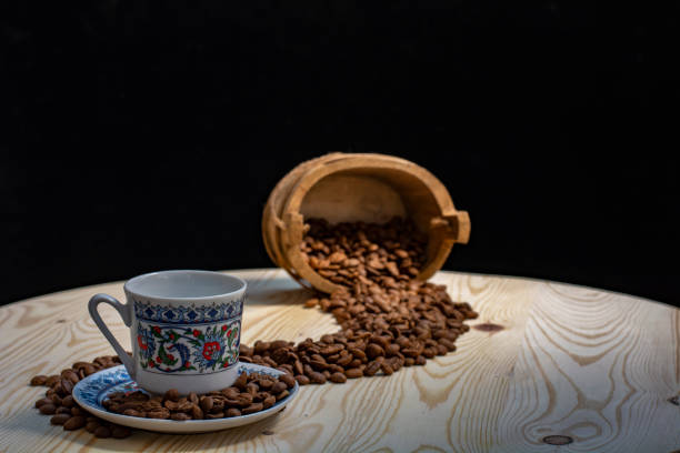 istock coffee cup, coffee grains on wooden table 1254238127