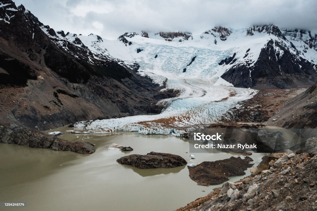 View on Glacier Torre and Laguna Torre in Patagonia, Argentina Majestic view of Glacier Torre and Laguna Torre with dramatic sky in springtime in Patagonia, Argentina Adventure Stock Photo