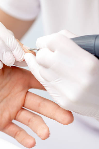 istock Manicure master uses an electric nail machine 1254245754