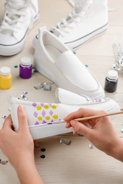 istock White slip-on with glamorous custom design. Artist painting 1254246748