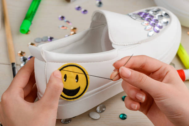 istock White shoe with rhinestones and embroidered smile badge 1254247133