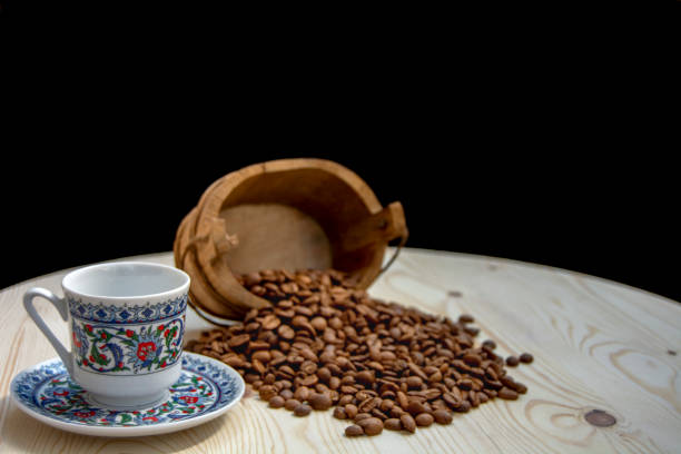 istock coffee cup, coffee grains on wooden table 1254248106