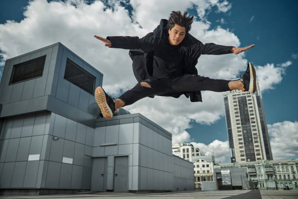 istock Good-looking young man jumping on the street 1254250583