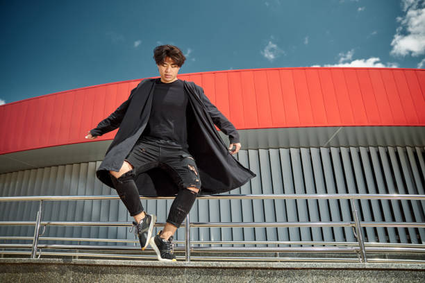 istock Handsome young man standing on one leg on the street 1254250609
