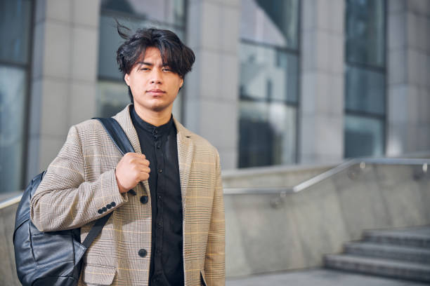 istock Good-looking young man standing on the street 1254250676