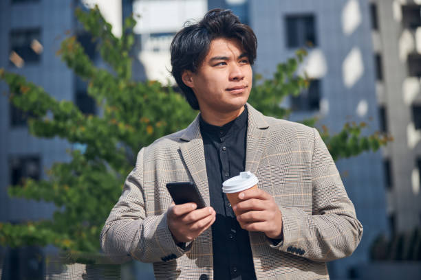 istock Attractive young man using mobile phone outdoors 1254250692